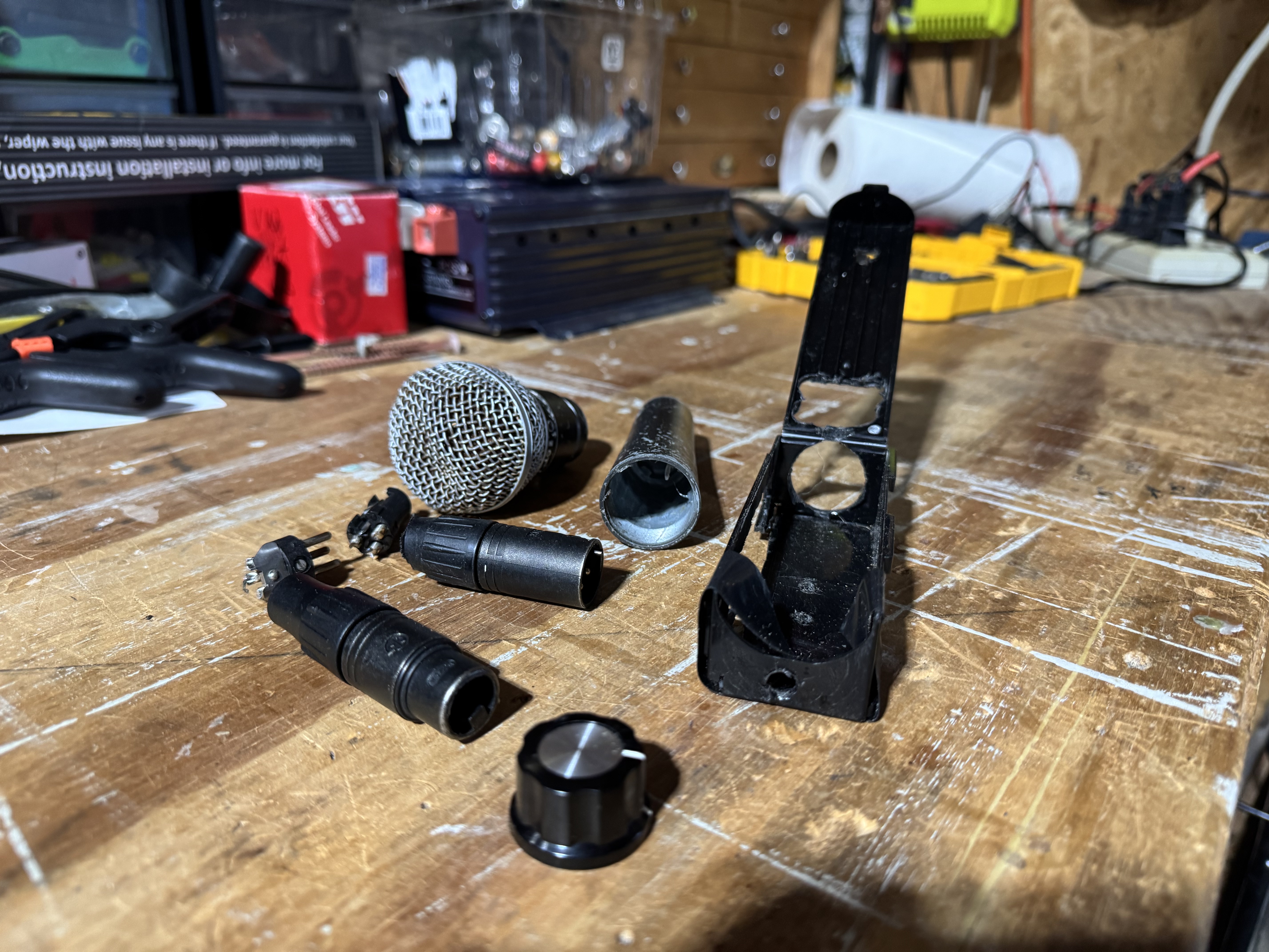 All parts laid out: SM58 cartridge, volume pot, printed shell, and hardware